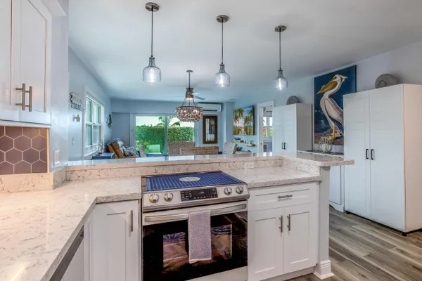a kitchen with a sink a counter space cabinets and appliances
