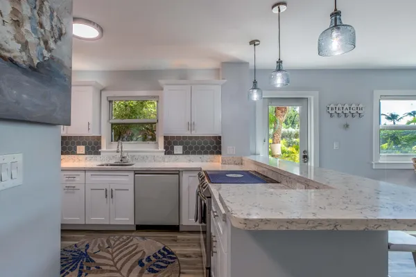 a view of a dining room with furniture wooden floor and chandelier