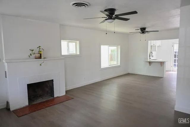 a living room with a fireplace and a window