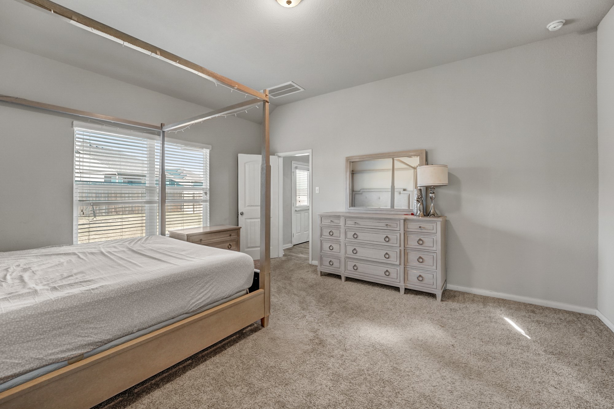 633 Donegal Lane Georgetown, TX 78626 - Photo 18 of 21 a bedroom with a bed a dresser and next to a window