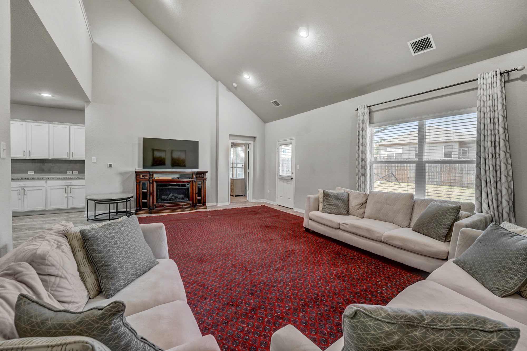 633 Donegal Lane Georgetown, TX 78626 - Photo 8 of 21 a living room with furniture a fireplace and a flat screen tv