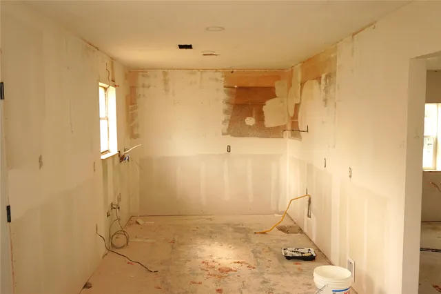 a view of a livingroom with wooden floor and a bathroom