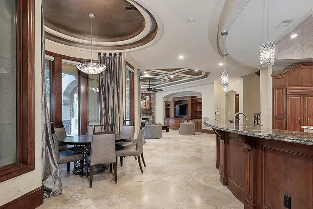 a very nice looking dining room with a large mirror and a dining table