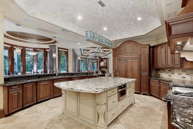 a kitchen with stainless steel appliances granite countertop a stove and a sink