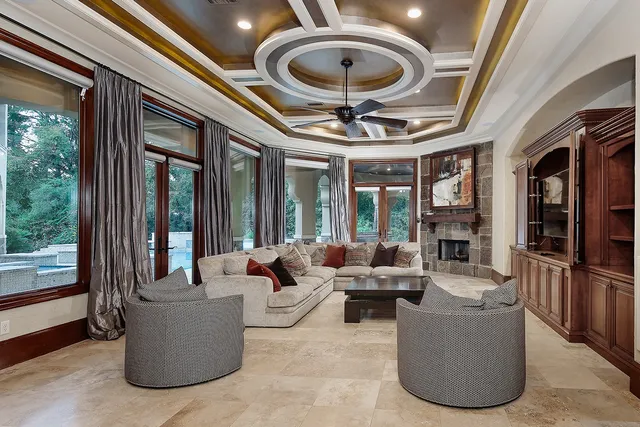 a living room with furniture and floor to ceiling window