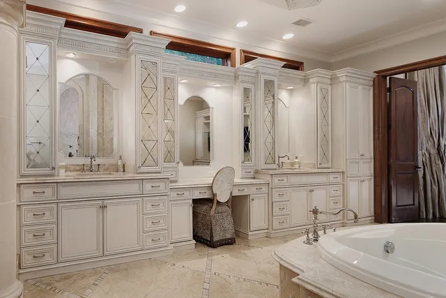 a bathroom with a granite countertop sink double vanity and a bathtub