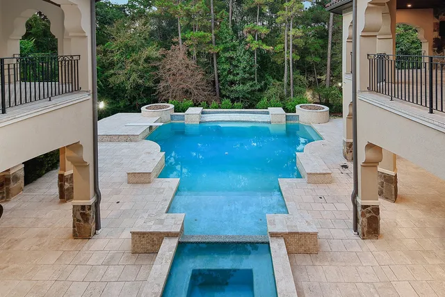 a view of a patio with couches table and chairs and potted plants