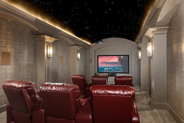 a media room with lots of chairs and a projector screen