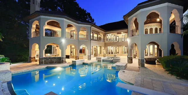 a view of a house with swimming pool and sitting area