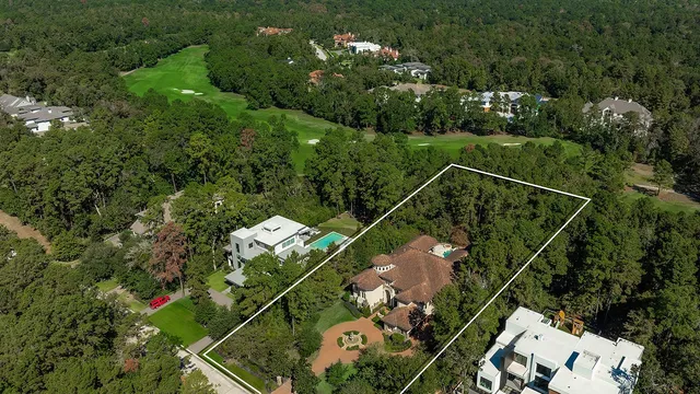 an aerial view of a house with garden space and street view