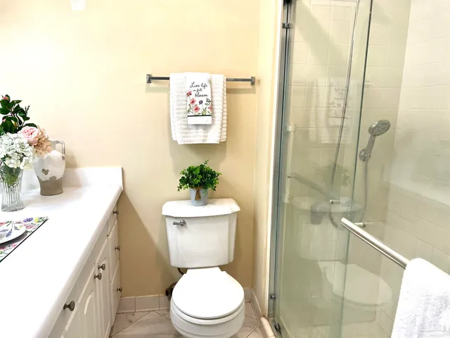a white toilet sitting next to a bathroom sink