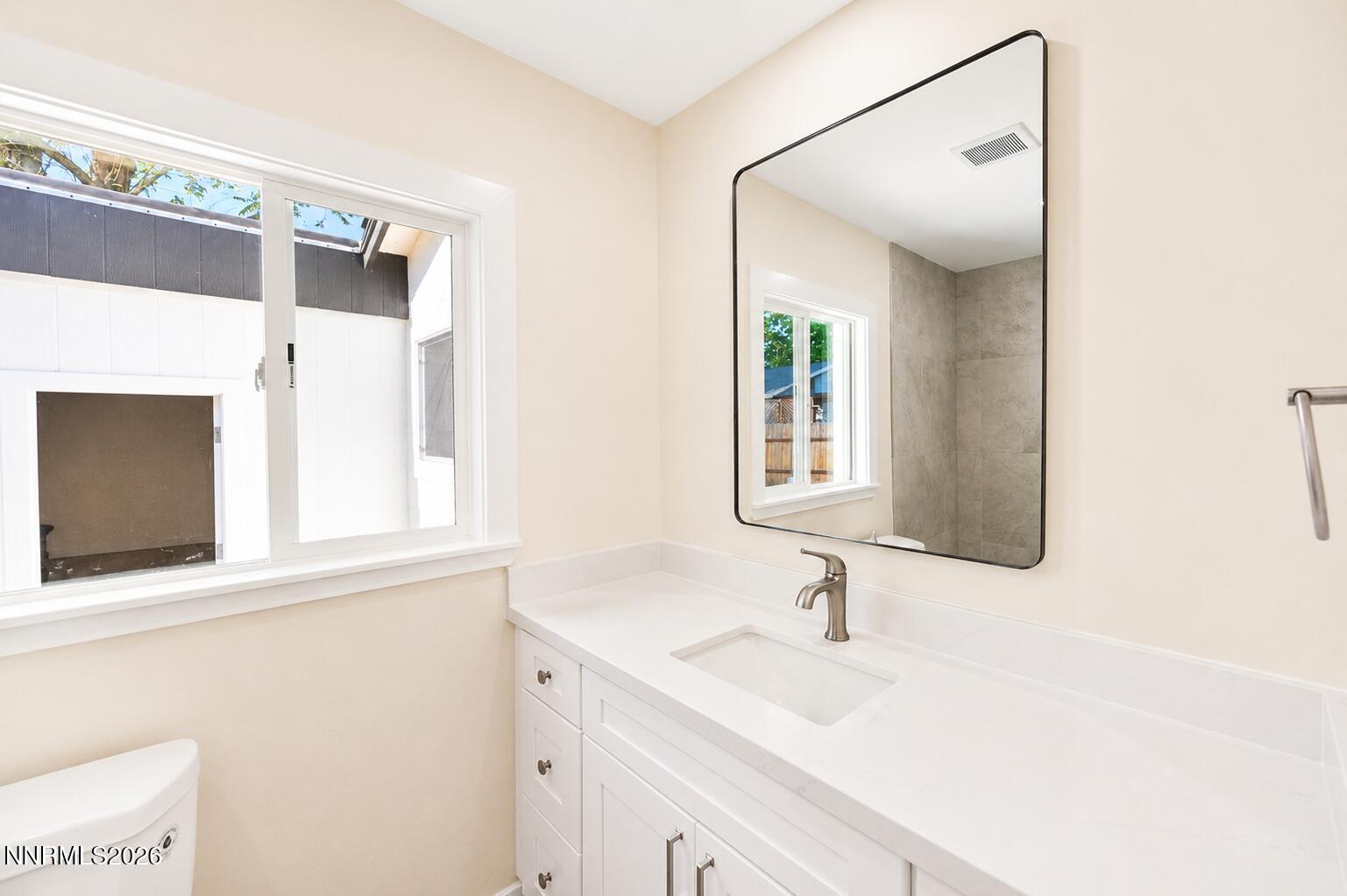 742 Ruth Street Carson City, NV 89701 - Photo 8 of 25 a bathroom with a sink and a mirror