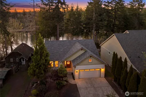 an aerial view of a residential houses with outdoor space and trees