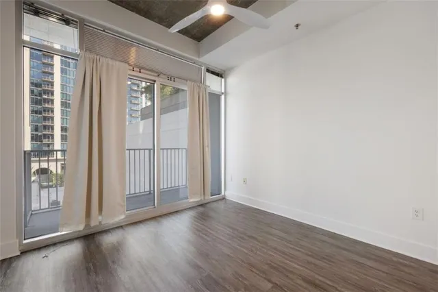 a view of a livingroom with wooden floor and window