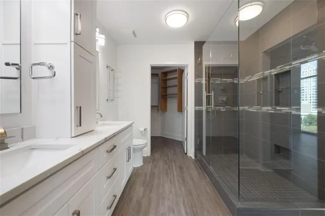 a bathroom with a granite countertop sink mirror and shower