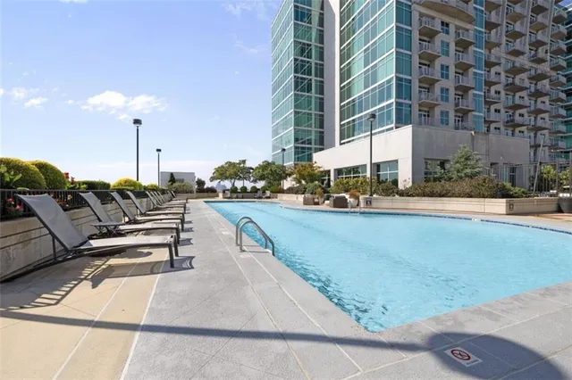 a view of a swimming pool with chairs