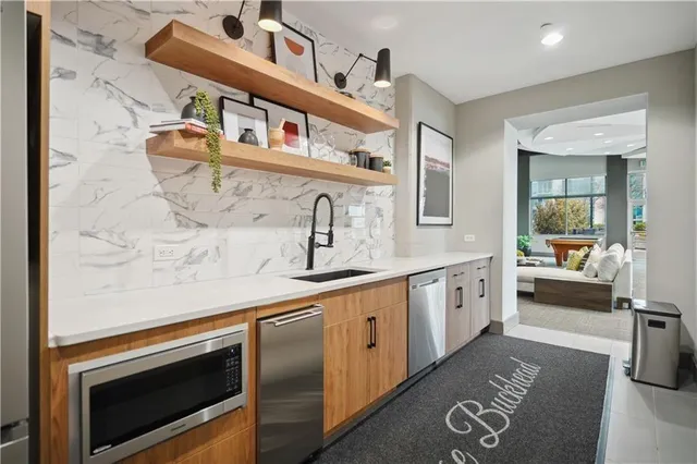 a kitchen with stainless steel appliances granite countertop a sink and cabinets