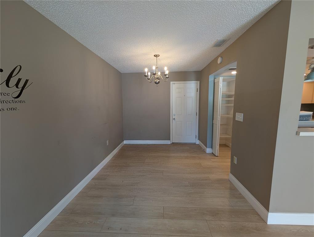 8161 Braddock Circle, Unit 1 Port Richey, FL 34668 - Photo 4 of 27 a view of a hallway with a chandelier fan