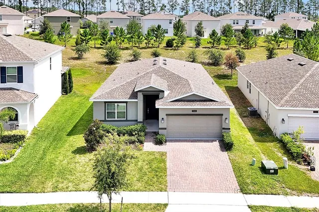 a aerial view of a house with a yard