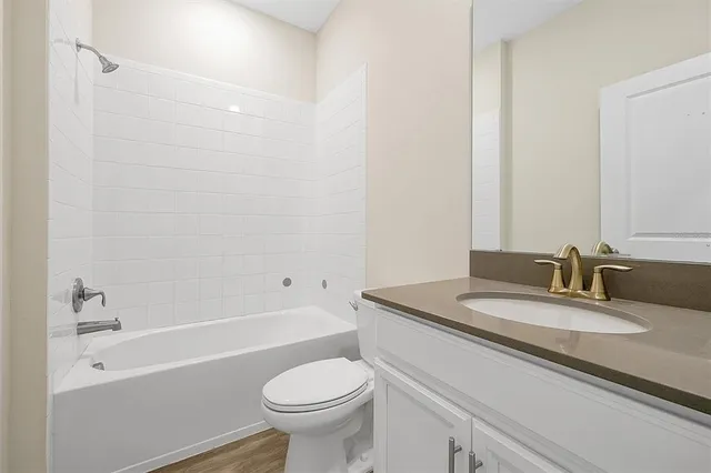 a bathroom with a sink a toilet and a bathtub