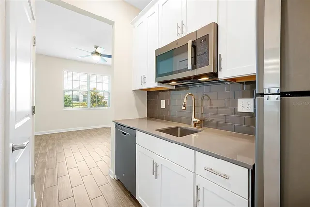 a kitchen with a sink and a microwave
