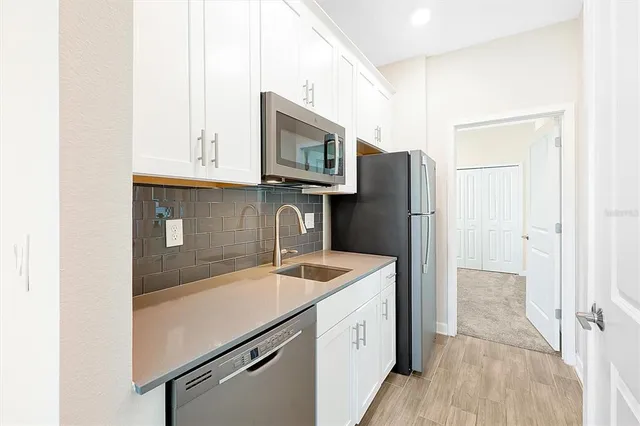 a kitchen with a sink and a refrigerator