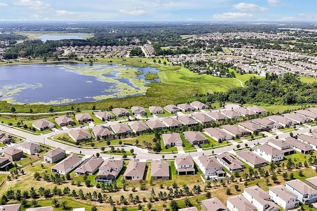 an aerial view of residential houses with outdoor space
