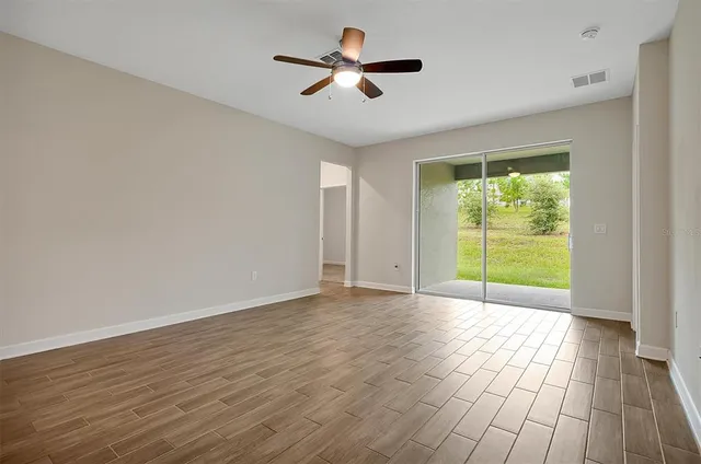 a view of an empty room with glass door