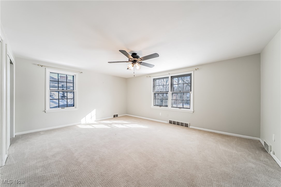 18201 Shelburne Road Cleveland, OH 44118 - Photo 23 of 36 Bedroom featuring ceiling fan, light carpet, and a wealth of natural light