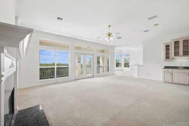 a bathroom with white cabinets and a wooden floor
