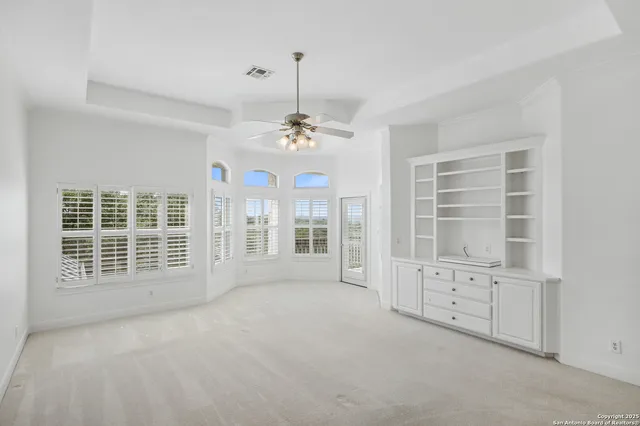 a view of a livingroom with a fireplace and window