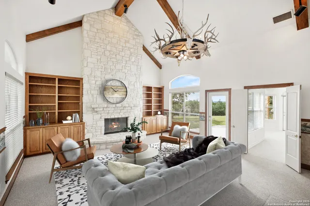 a view of an empty room with a fireplace and a window