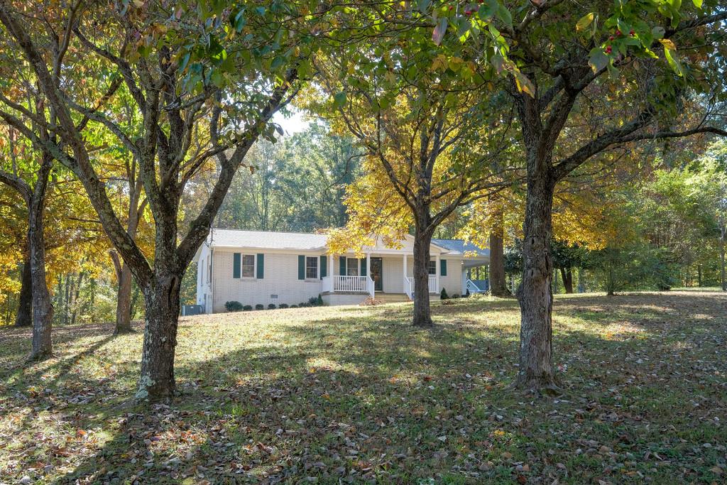 6615 Slaughter Road Santa Fe, TN 38482 - Photo 1 of 30 a house with trees in front of it