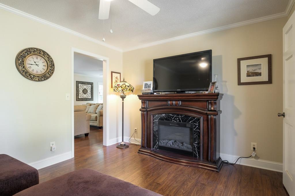 6615 Slaughter Road Santa Fe, TN 38482 - Photo 11 of 30 a living room with furniture a fireplace and a flat screen tv
