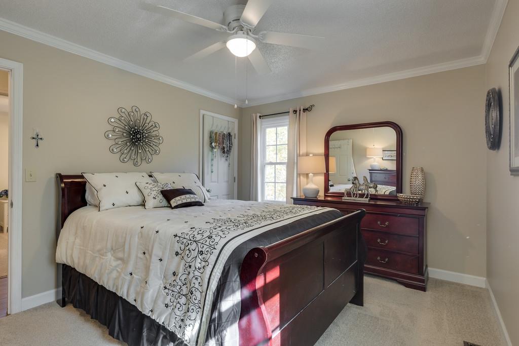 6615 Slaughter Road Santa Fe, TN 38482 - Photo 18 of 30 a bedroom with a bed and a large mirror on the dresser
