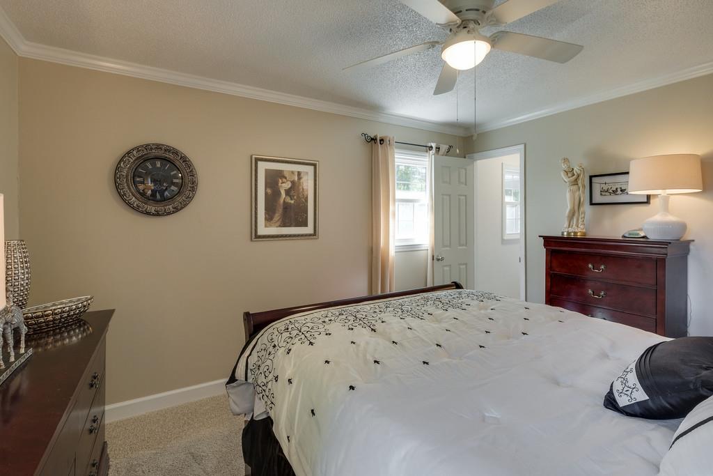 6615 Slaughter Road Santa Fe, TN 38482 - Photo 19 of 30 a bedroom with a bed and a chandelier