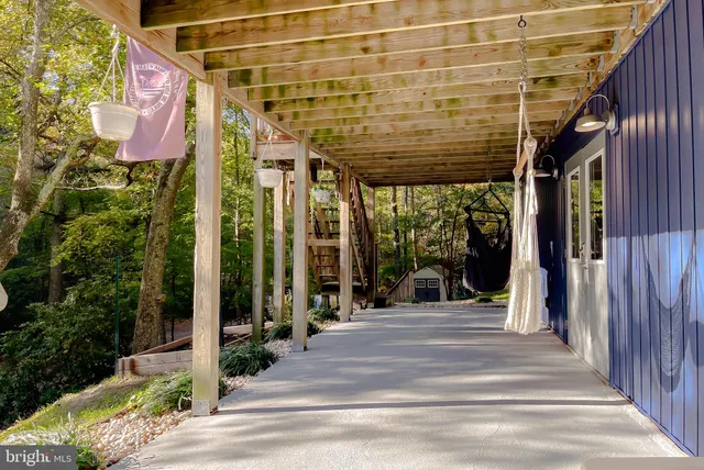 a kitchen with stainless steel appliances granite countertop a table chairs sink and cabinets