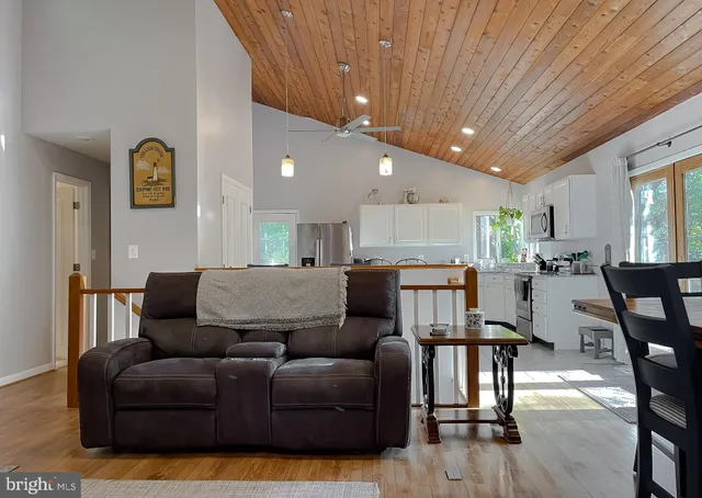 a bathroom with a sink a toilet a mirror and shower