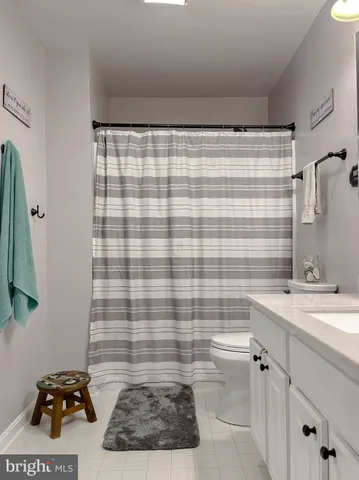 a bedroom with a bed window and dresser