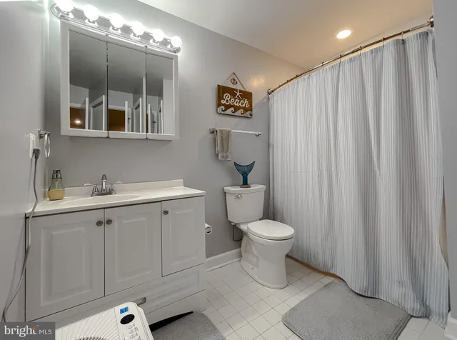 a view of a hallway with wooden floor and a living room