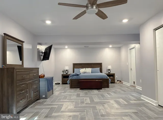 a view of a hallway with wooden floor and a living room