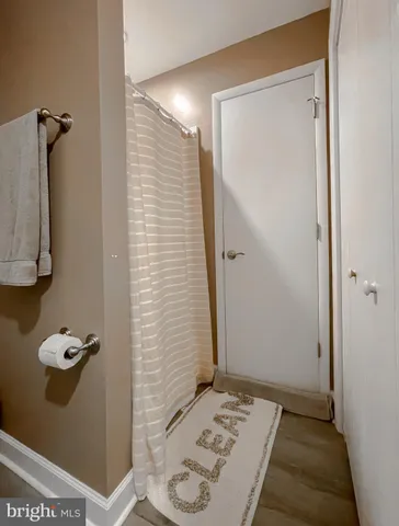 a backyard of a house with table and chairs with plants and wooden fence