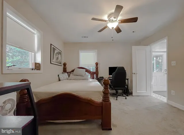 a view of a wooden house with a large tree