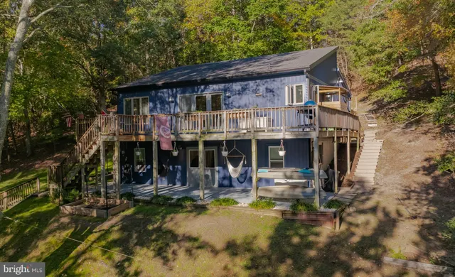 a view of a balcony with wooden floor and fence