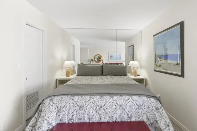 a bedroom with a large bed and a couch