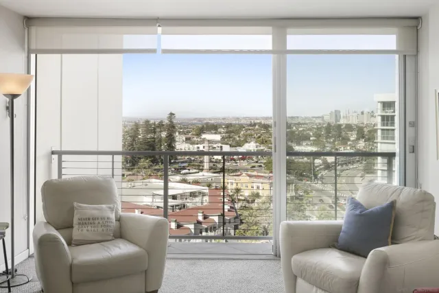 a view of a living room filled with furniture and a window