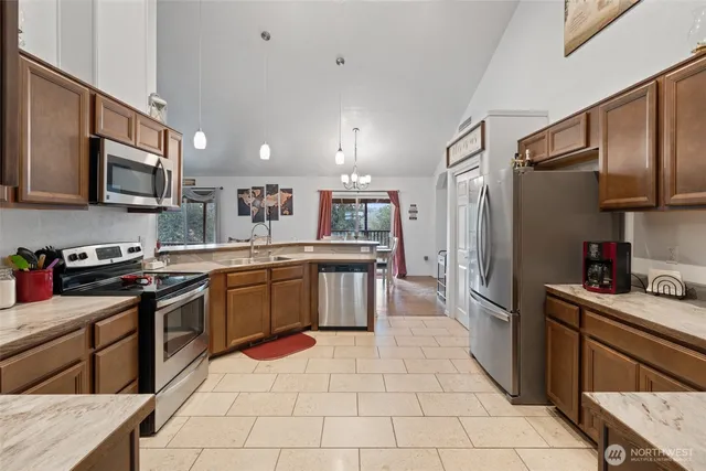 a kitchen with stainless steel appliances granite countertop a refrigerator sink and cabinets