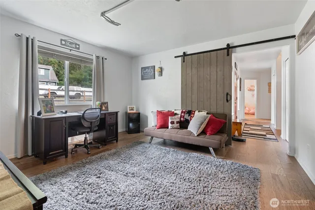 a living room with furniture rug and window