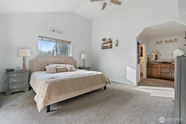 a spacious bedroom with a bed and a cabinets