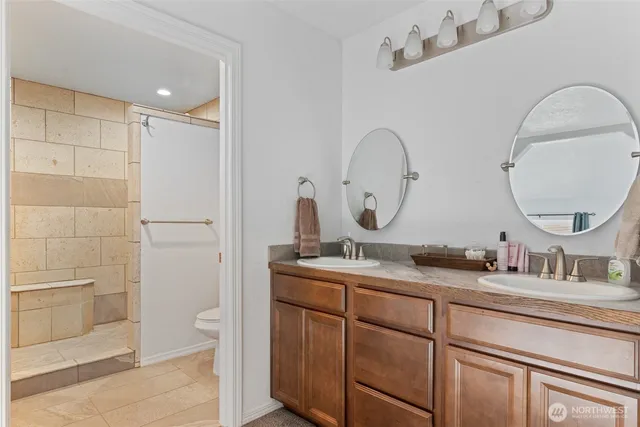 a bathroom with a double vanity sink and a mirror